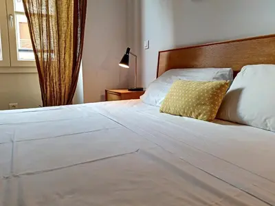 a bedroom with a white bed with a yellow pillow at Nestor&Jeeves - COLIBRI PRESTIGE - Central - Close sea in Nice