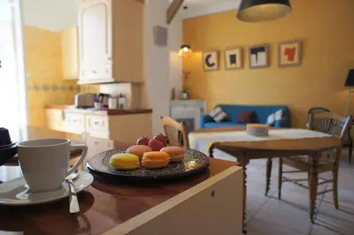 a table with a plate of donuts and a cup of coffee at ZePerfectPlace - Vieux Nice Garibaldi 3 chambres in Nice