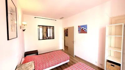 a small room with a red bed and a mirror at ZePerfectPlace - Vieux Nice Garibaldi 3 chambres in Nice