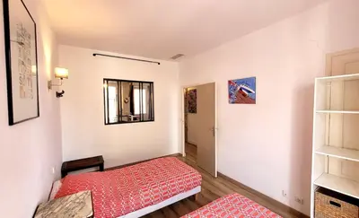 a small room with a red bed and a window at ZePerfectPlace - Vieux Nice Garibaldi 3 chambres in Nice