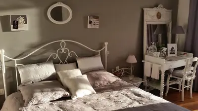 a bedroom with a bed and a desk and a mirror at La Tuiliere in Saint-Laurent-du-Var