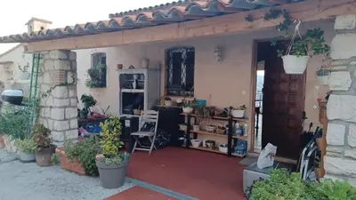 a house with a garage with plants in it at La Tuiliere in Saint-Laurent-du-Var