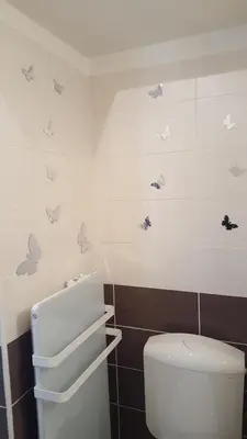 a bathroom with a toilet and butterflies on the wall at Nice Centre, Magnifique Studio Proche Mer in Nice