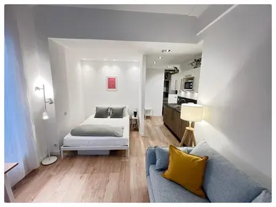 a living room with a bed and a couch at Maison de Côte - Felice in Nice