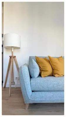 a blue couch with yellow pillows next to a lamp at Maison de Côte - Felice in Nice