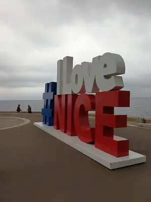 a large red white and blue love me sign on the beach at Breakfast at Sophy's in Nice
