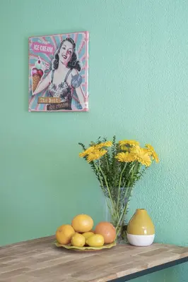 a picture of a woman on top of a shelf with flowers at Cosy apartment Promenade des Anglais in Nice
