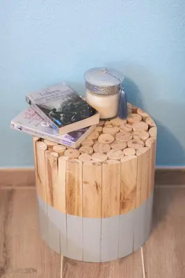 a round wooden table with books and a candle on it at Cosy apartment Promenade des Anglais in Nice