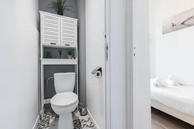 a bathroom with a white toilet in a room at Sea View - Promenade des Anglais 1 Bdr in Nice