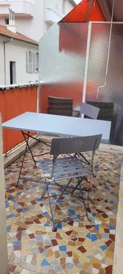 a table on a patio with a mosaic floor at Nice Centre, Superbe Studio Proche Mer in Nice