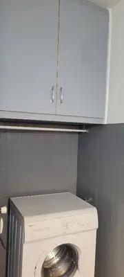 a washing machine in a bathroom with a cabinet above it at Nice Centre, Superbe Studio Proche Mer in Nice