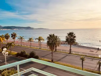 a view of the beach and a road with palm trees at Appartement 2 chambres avec Terrasse Vue sur la Mer in Nice