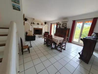 a living room with a table and chairs and a fireplace at Villa de charme à La Gaude avec piscine privée in La Gaude
