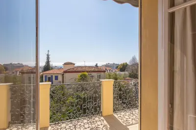 a balcony with a view of a city at Penthouse Lou Lòu by iVillamia com in Nice