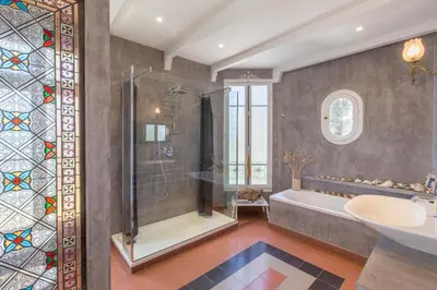 a bathroom with a shower and a tub and a sink at Penthouse Lou Lòu by iVillamia com in Nice
