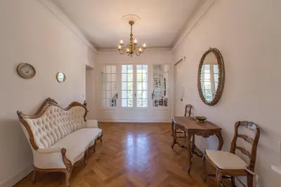 a living room with a couch and a table at Penthouse Lou Lòu by iVillamia com in Nice