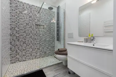 a white bathroom with a shower and a toilet at Olma in Nice