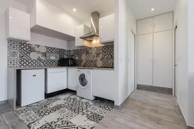 a kitchen and living room with a washing machine at Olma in Nice