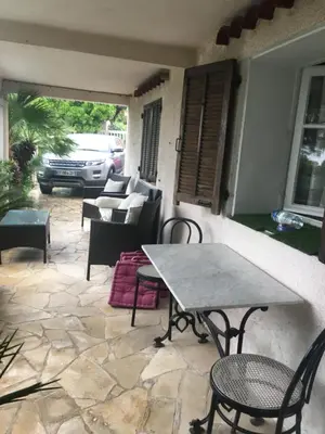 a patio with a table and chairs on a patio at La Nectarine in Nice
