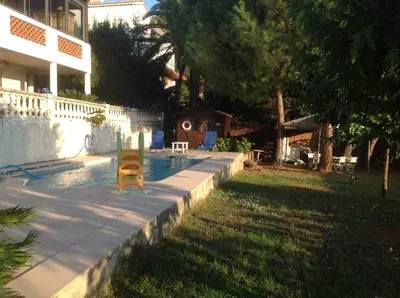 a pool with a yellow chair next to a house at La Nectarine in Nice