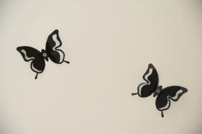 three black butterflies flying on a white background at Suite Imperazur Five stars Holiday House in Nice