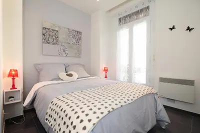 a white bedroom with a bed with a hat on it at Suite Imperazur Five stars Holiday House in Nice