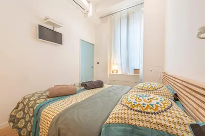 a bedroom with a bed with a blanket on it at Grimaldi in Nice