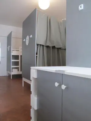 a bathroom with a sink and a bed in a room at La Maïoun Guesthouse in Nice