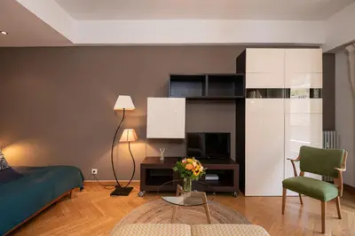 a bedroom with a bed and a table and a chair at Appartement Musiciens in Nice