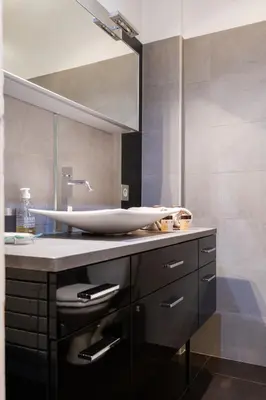 a bathroom with a sink and a mirror at Appartement Musiciens in Nice