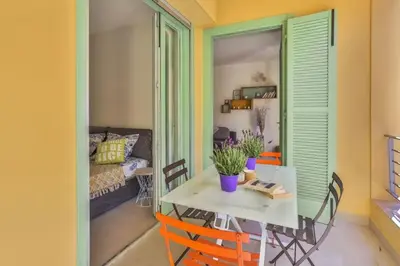 a room with a table and chairs and a couch at MY CASA - FRANCE 82 TP -1 min from the Sea - Terrace - Parking in Nice