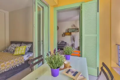 a living room with a table and a couch at MY CASA - FRANCE 82 TP -1 min from the Sea - Terrace - Parking in Nice