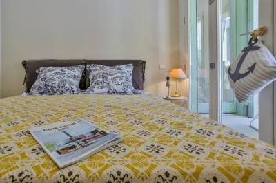 a bedroom with a bed with a magazine on it at MY CASA - FRANCE 82 TP -1 min from the Sea - Terrace - Parking in Nice