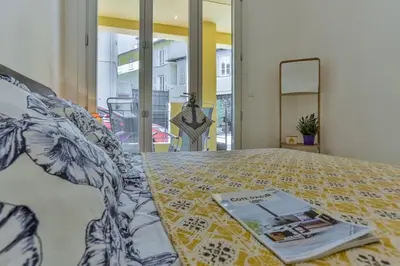 a book sitting on top of a bed at MY CASA - FRANCE 82 TP -1 min from the Sea - Terrace - Parking in Nice