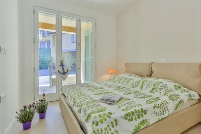 a bedroom with a bed and a window with plants at MY CASA - FRANCE 82 TP -1 min from the Sea - Terrace - Parking in Nice