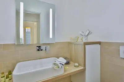a bathroom with a white sink and a mirror at MY CASA - FRANCE 82 TP -1 min from the Sea - Terrace - Parking in Nice