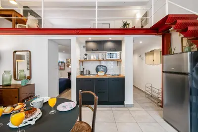 a kitchen and dining room with a table and a refrigerator at Nice-Duplex-Plage-Climatisation in Nice