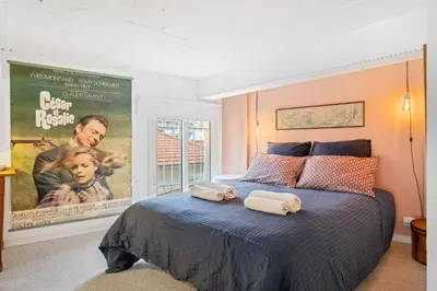 a bedroom with a bed with two rolled towels on it at Nice-Duplex-Plage-Climatisation in Nice