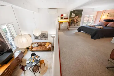 a bedroom and living room with a bed and a couch at Nice-Duplex-Plage-Climatisation in Nice