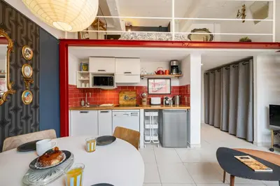 a living room with a couch and a table at Nice-Duplex-Plage-Parking-Cimatisation in Nice