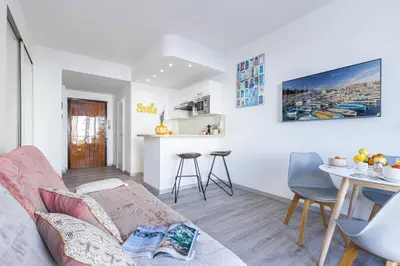 a living room with a couch and a table at MY CASA - BUFFA 21 - 2min from the Sea - Terrace in Nice