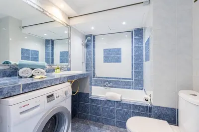 a blue tiled bathroom with a washing machine at MY CASA - BUFFA 21 - 2min from the Sea - Terrace in Nice