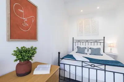 a bedroom with a bed and a table with a plant at MY CASA - BUFFA 21 - 2min from the Sea - Terrace in Nice
