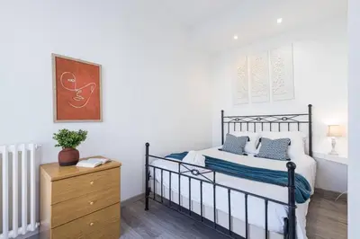 a bedroom with a black and white bed and a dresser at MY CASA - BUFFA 21 - 2min from the Sea - Terrace in Nice