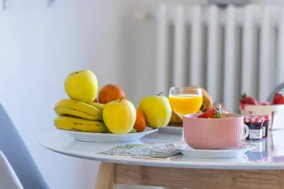 a table topped with plates of fruit and glasses of orange juice at MY CASA - BUFFA 21 - 2min from the Sea - Terrace in Nice