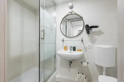 a white bathroom with a sink and a mirror at MY CASA - FRICERO - Comfortable 5 people- 200m near the Sea in Nice