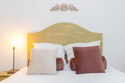 a bedroom with a bed with pillows on it at MY CASA - FRICERO - Comfortable 5 people- 200m near the Sea in Nice