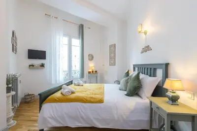 a bedroom with a bed and a desk and a window at MY CASA - FRICERO - Comfortable 5 people- 200m near the Sea in Nice