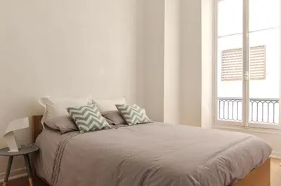 a bedroom with a bed with two pillows on it at MY CASA - VEILLON - 2 bedrooms - City Center in Nice