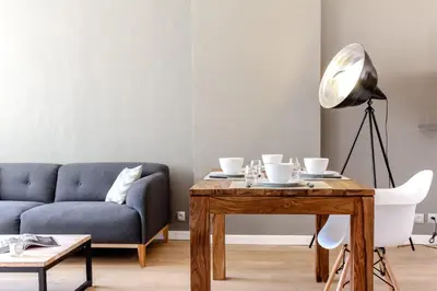 a living room with a table and a couch at MY CASA - VEILLON - 2 bedrooms - City Center in Nice